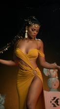 Load image into Gallery viewer, Model wears strappy stylish halter mustard dress designed by Best Caribbean Fashion Designer in Trinidad, Jin Forde.
